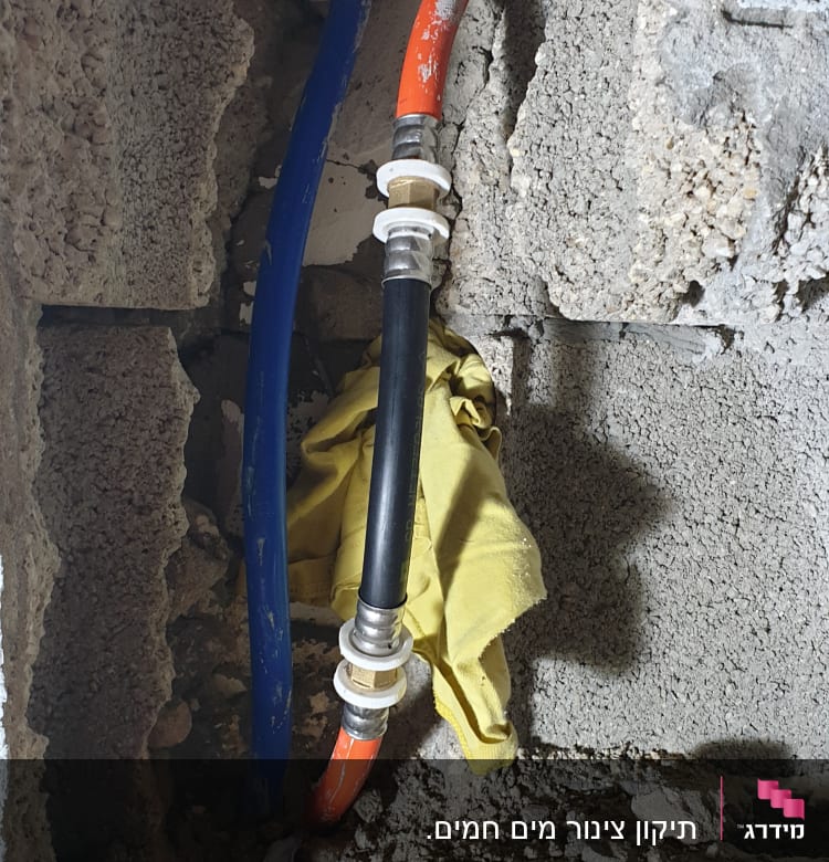 צינורות מים כחול ואדום בקיר בטון